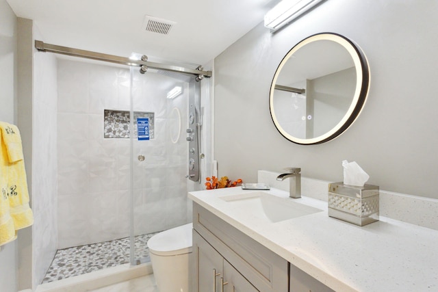 bathroom with vanity, toilet, and an enclosed shower