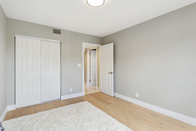 bedroom featuring wood-type flooring and a closet