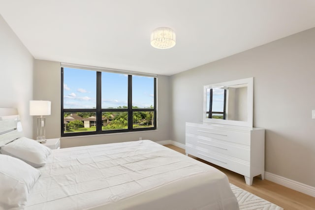 bedroom featuring hardwood / wood-style floors and multiple windows