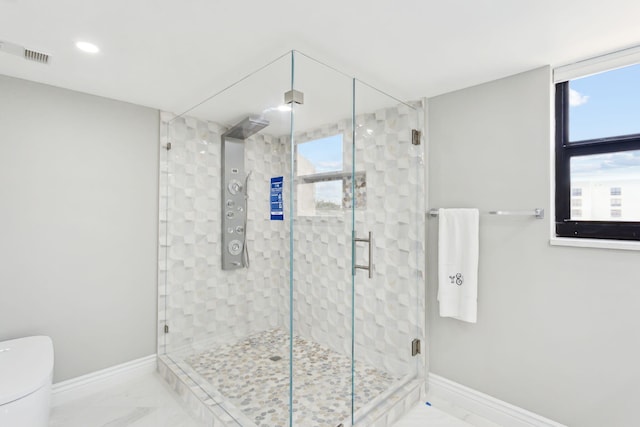 bathroom with walk in shower and toilet