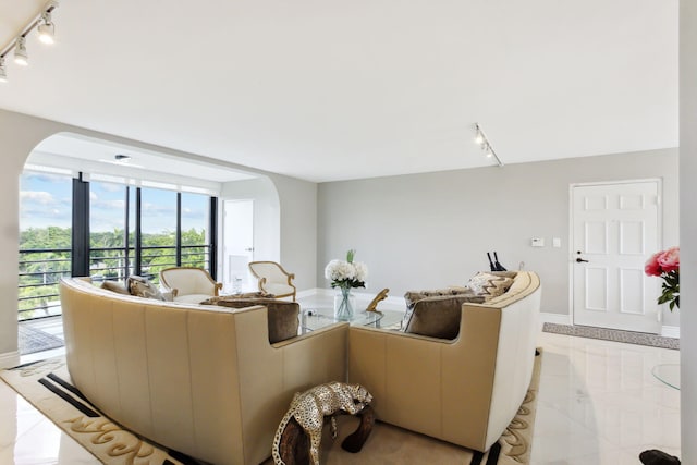 tiled living room featuring track lighting