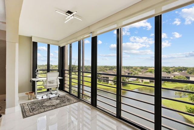 unfurnished sunroom with a water view and a wealth of natural light