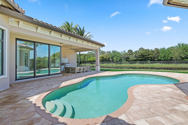 view of swimming pool with a patio area, an outdoor living space, and ceiling fan