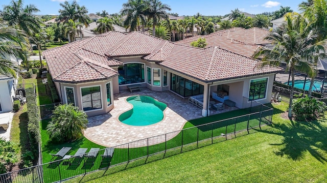 rear view of house featuring a lawn, a fenced in pool, and a patio