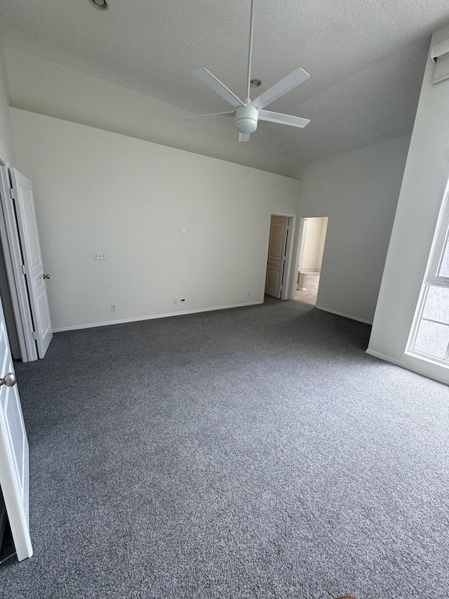 unfurnished bedroom featuring ceiling fan, a textured ceiling, and dark carpet