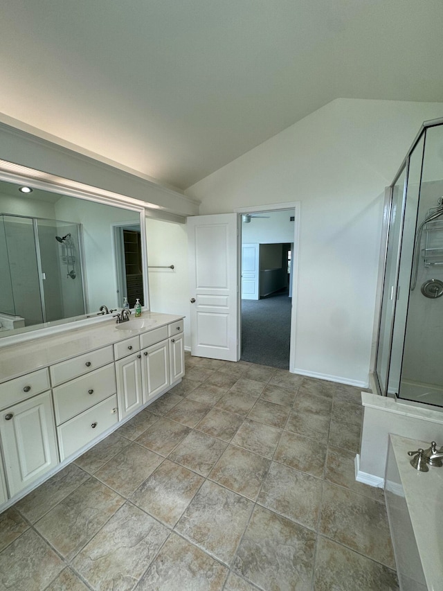 bathroom with lofted ceiling, vanity, and separate shower and tub