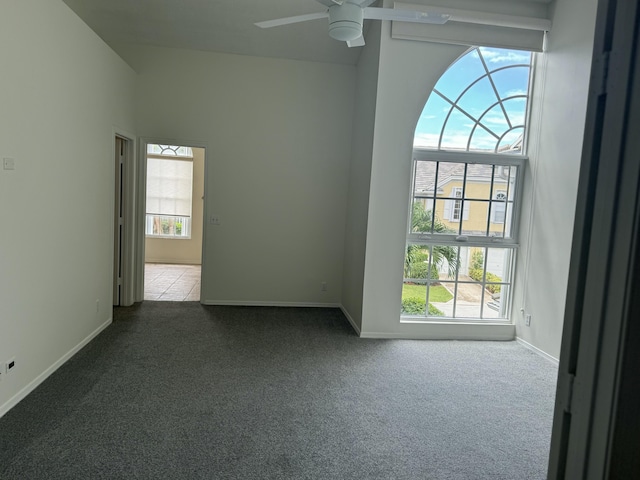 spare room featuring carpet floors and ceiling fan