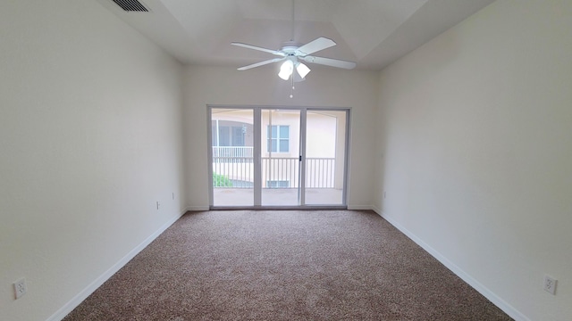 carpeted spare room with baseboards, visible vents, a ceiling fan, and vaulted ceiling
