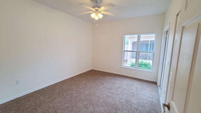 unfurnished room featuring carpet, a ceiling fan, and baseboards