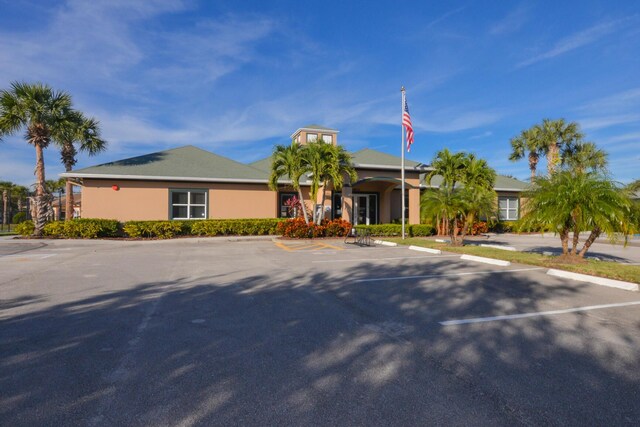 1840 S Dovetail Dr, Fort Pierce, FL 34982 - view of front of home with uncovered parking and stucco siding