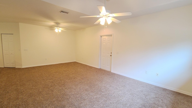 spare room with ceiling fan, baseboards, visible vents, and carpet flooring