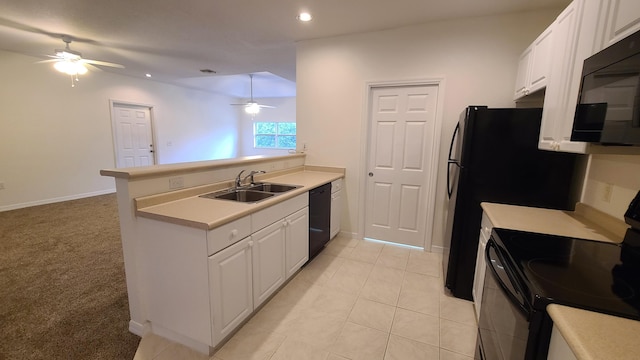 kitchen featuring a sink, black appliances, a ceiling fan, a peninsula, and white cabinetry