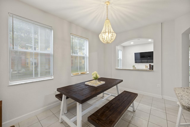 dining room featuring light tile patterned floors and a notable chandelier