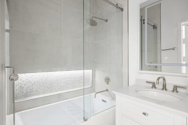 bathroom featuring vanity and bath / shower combo with glass door