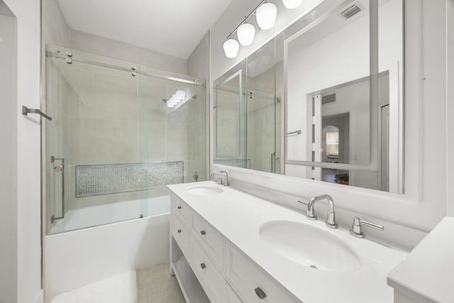 bathroom featuring shower / bath combination with glass door and vanity