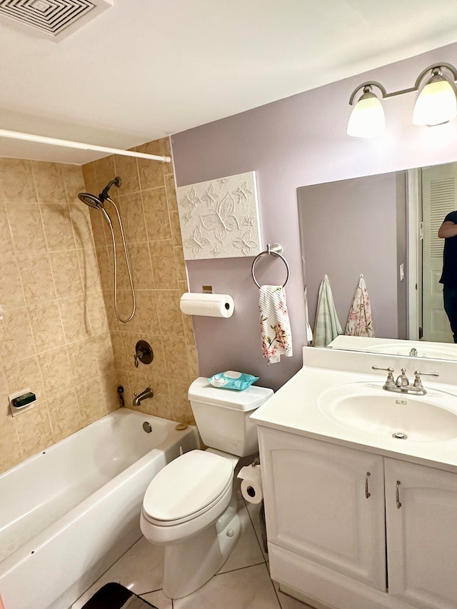 full bathroom featuring tiled shower / bath, vanity, tile patterned flooring, and toilet