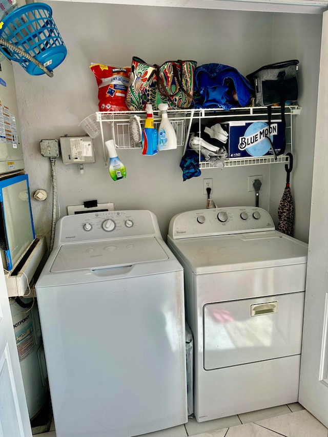 washroom with independent washer and dryer and light tile patterned floors