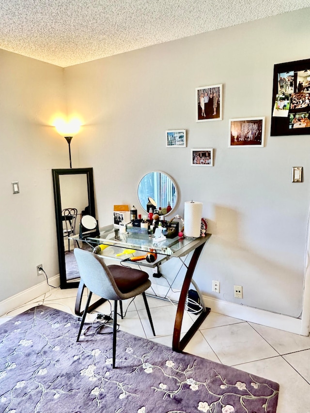 tiled home office with a textured ceiling