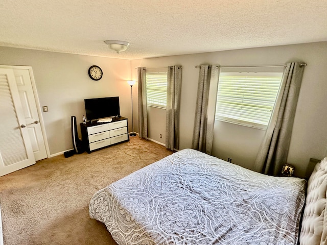 carpeted bedroom featuring a textured ceiling