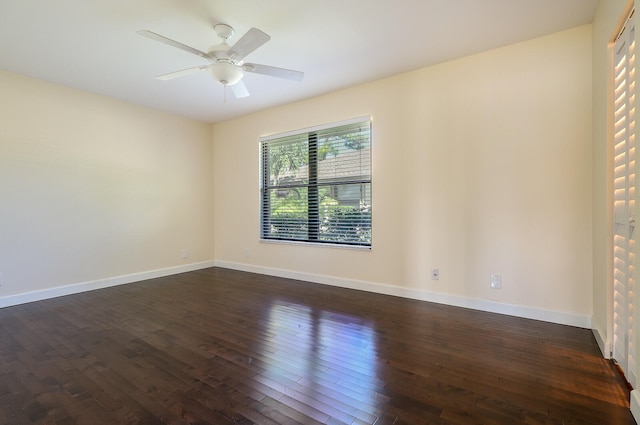 empty room featuring ceiling fan and dark hardwood / wood-style floors