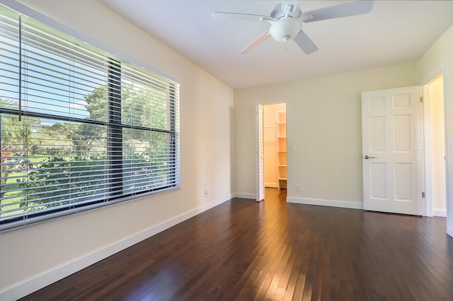 unfurnished room with dark hardwood / wood-style floors and ceiling fan