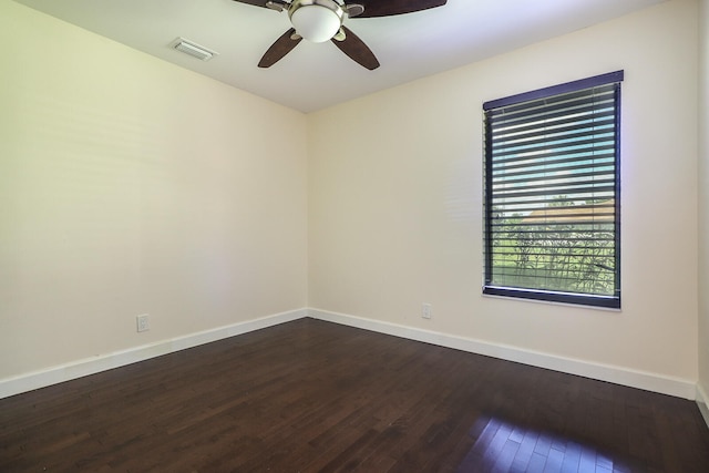 unfurnished room with ceiling fan and dark wood-type flooring