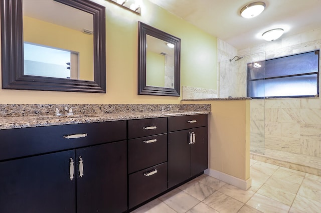 bathroom featuring vanity and tiled shower