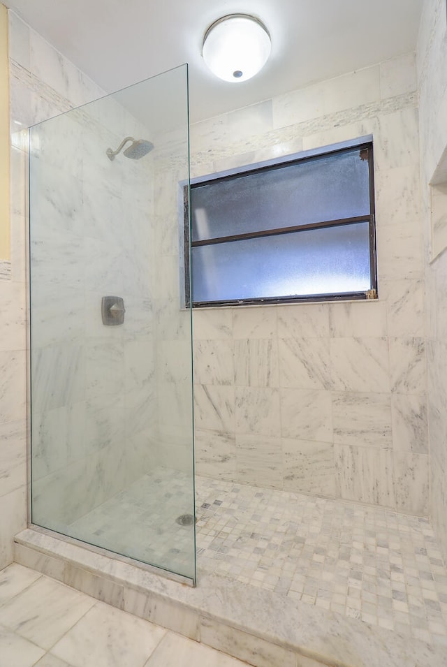 bathroom with a tile shower