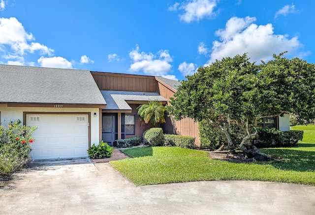 view of front of house with a front yard and a garage