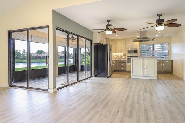 kitchen with a healthy amount of sunlight, stainless steel appliances, and island range hood