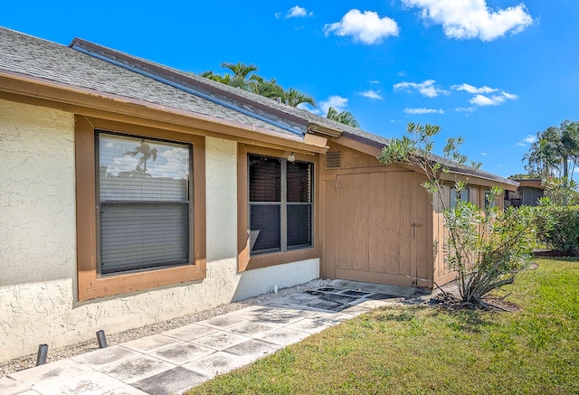 property entrance featuring a lawn