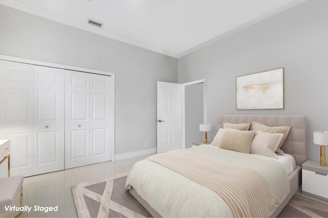 bedroom with crown molding and a closet