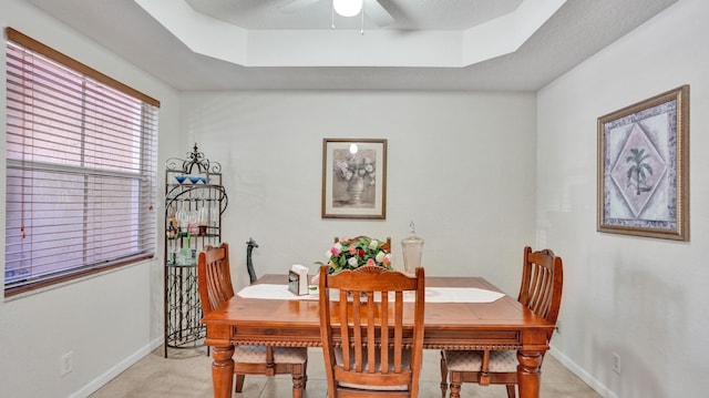 dining area featuring a tray ceiling and ceiling fan