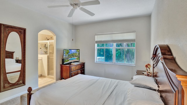 carpeted bedroom with ceiling fan and ensuite bathroom