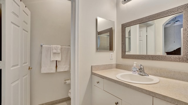 bathroom featuring vanity and toilet