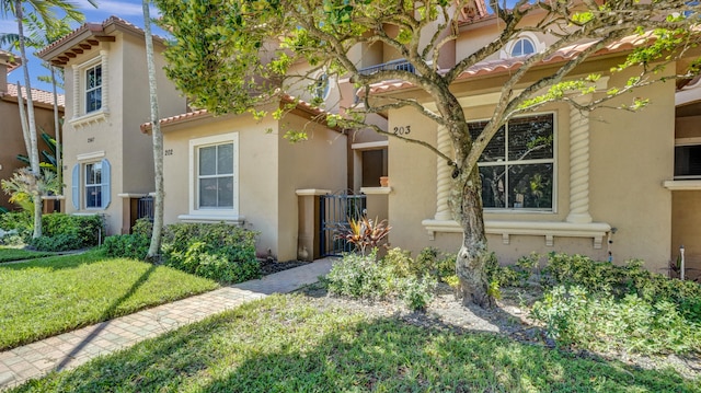 mediterranean / spanish home featuring a front lawn