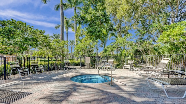 view of pool featuring a patio area and a hot tub