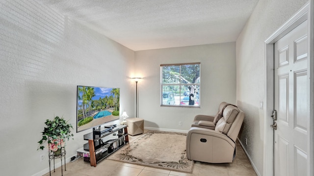 sitting room featuring a textured ceiling and light tile patterned floors