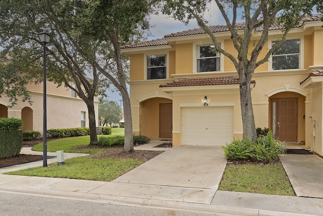 mediterranean / spanish-style house featuring a front yard and a garage