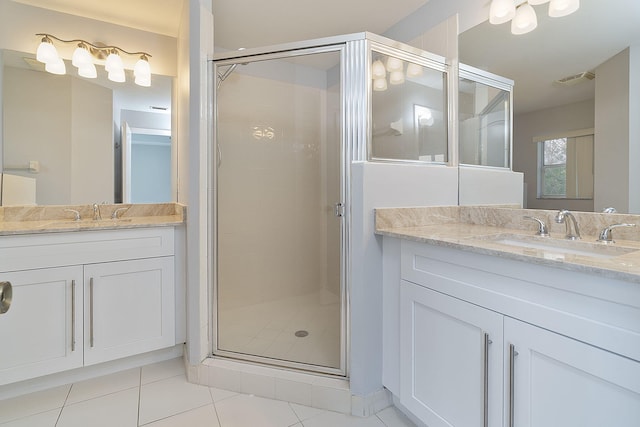 bathroom with vanity, a shower with door, and tile patterned floors