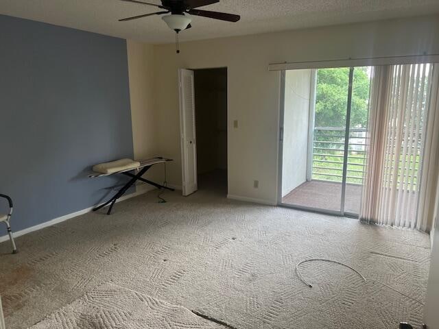 spare room with ceiling fan, carpet flooring, and a textured ceiling