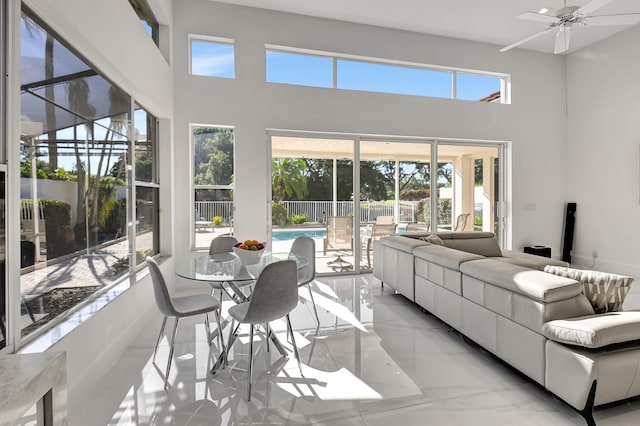 sunroom featuring ceiling fan