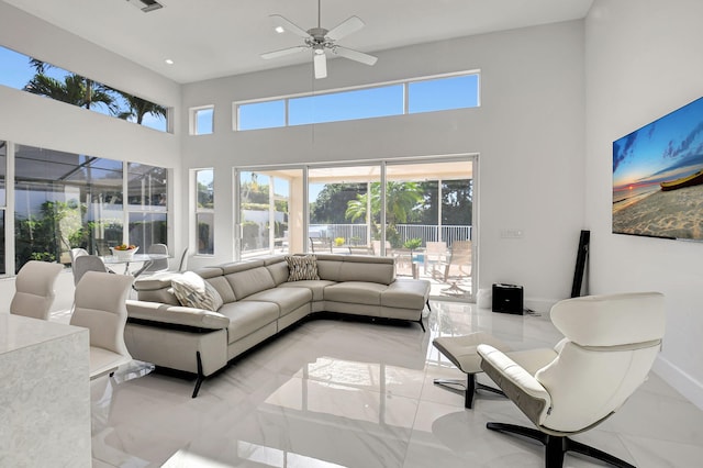 living room featuring a high ceiling and ceiling fan