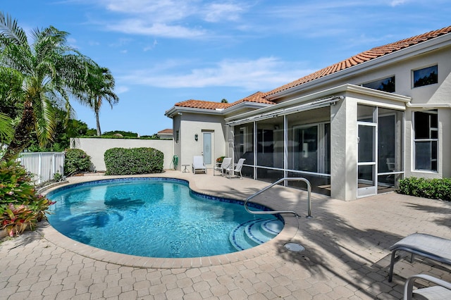 view of pool featuring a patio and a sunroom