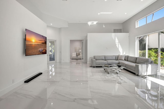 unfurnished living room with a towering ceiling