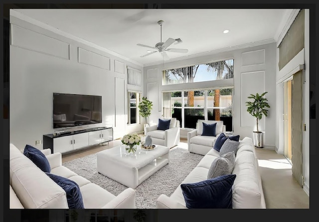 living room featuring ceiling fan and crown molding