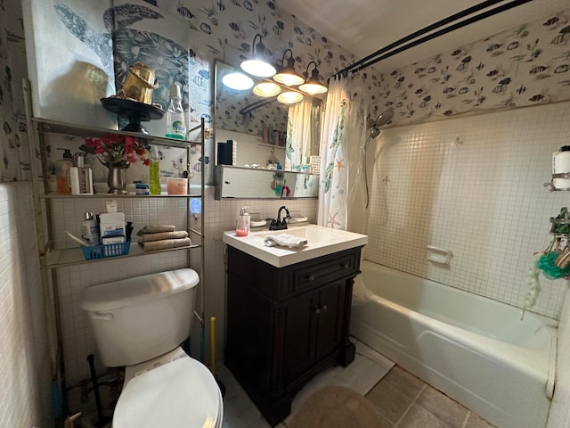 full bathroom featuring tile patterned flooring, toilet, shower / tub combination, vanity, and tile walls