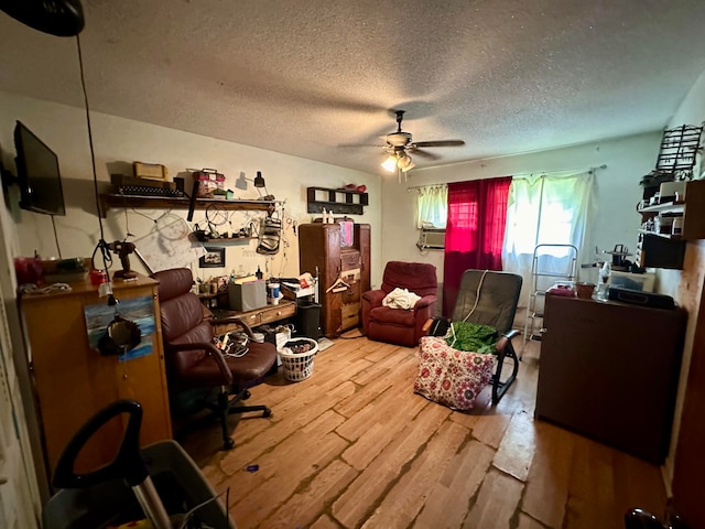 office featuring a textured ceiling, hardwood / wood-style flooring, ceiling fan, and cooling unit