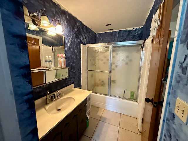 bathroom with shower / bath combination with glass door, tile patterned flooring, and vanity