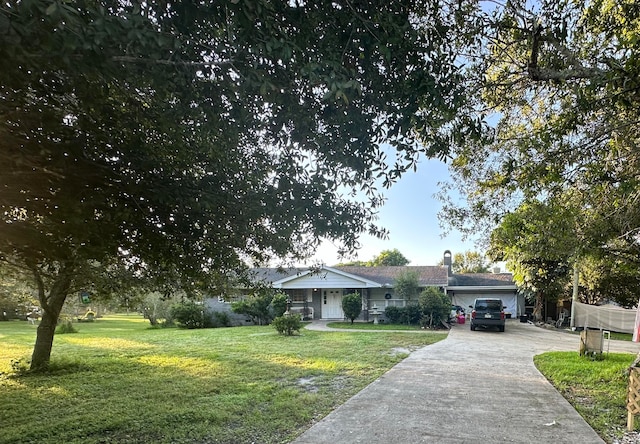 ranch-style home featuring a garage and a front lawn